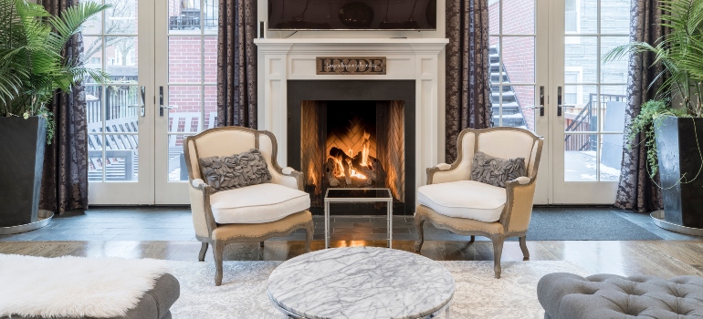 two chairs next to a fireplace