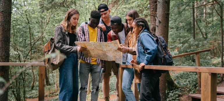 a group of friends in a park looking at the map