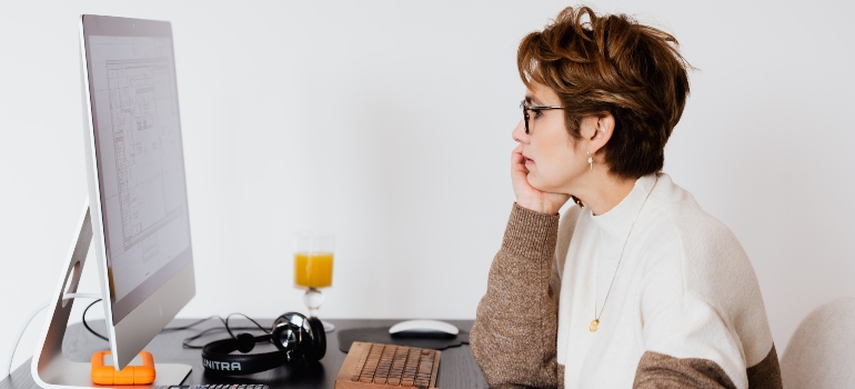 a woman using a computer to research about moving from Oshawa to Vaughan