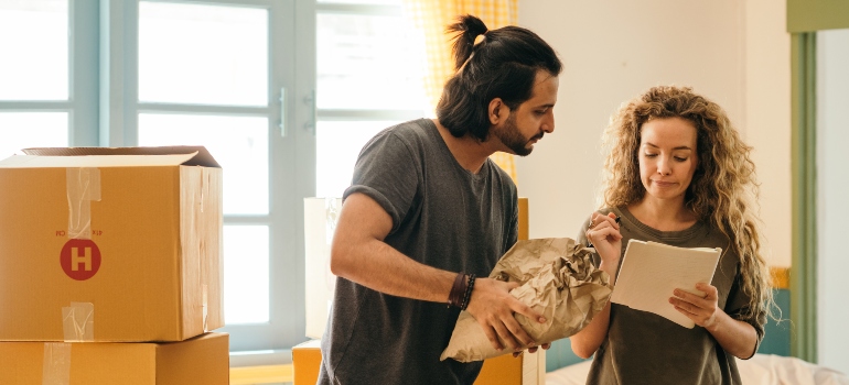 a couple packing after learning how insurance can save you from potential moving disasters
