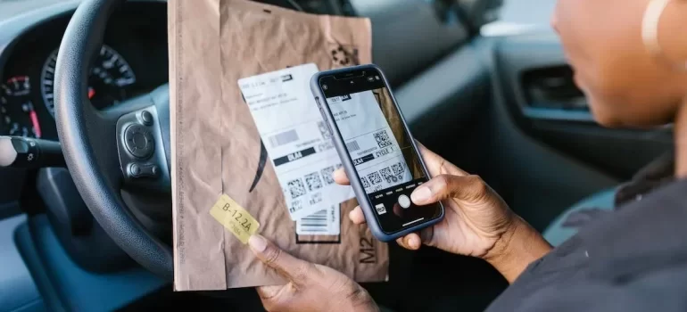 A man checking his phone in the car
