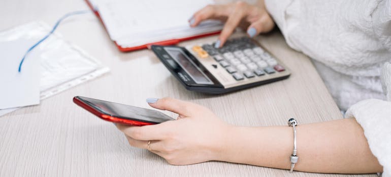 A person calculating cost of living before they move to Moncton