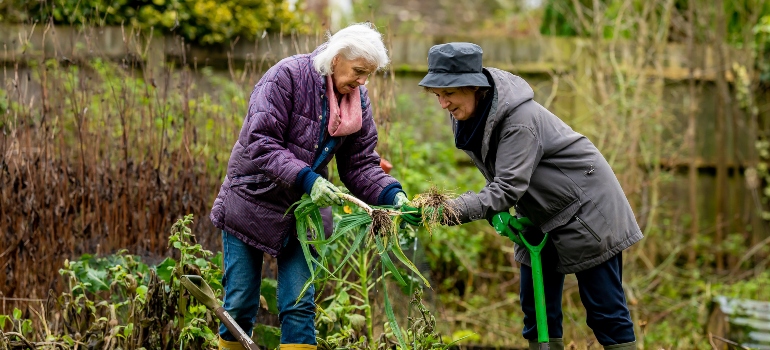 Two women farming and talking about tips for seniors to feel at home