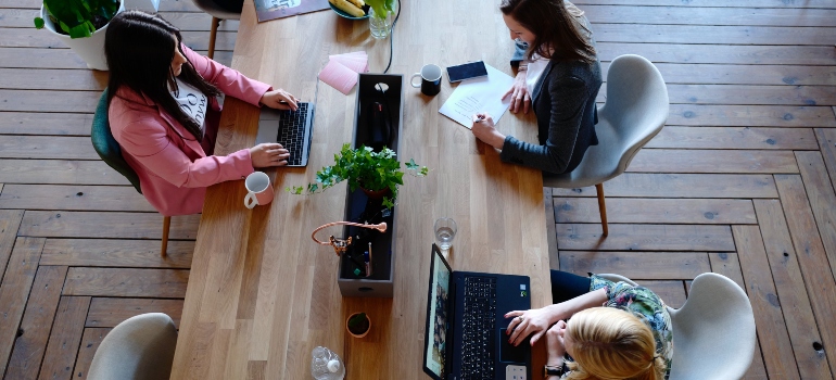 Women working at a desk in one of the best cities to start a business in Canada