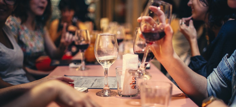 people in a restaurant holding wine glasses
