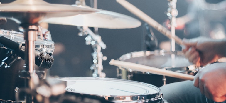A person playing drums during a music performance