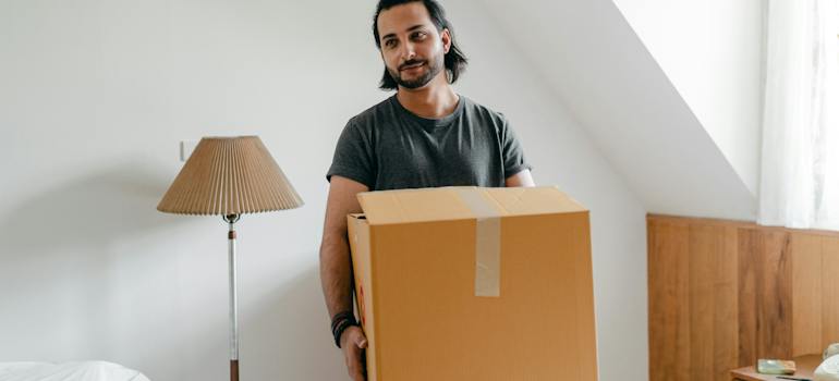 A person packing, preparing for their move to Moncton