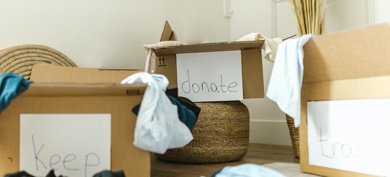 Boxes with items to donate, keep and throw away