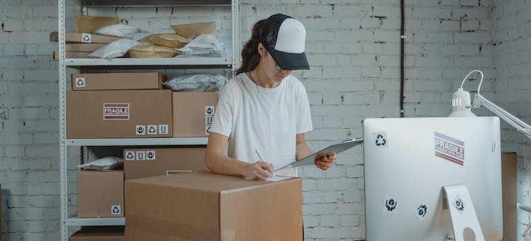 An employee of a storage company labeling a box