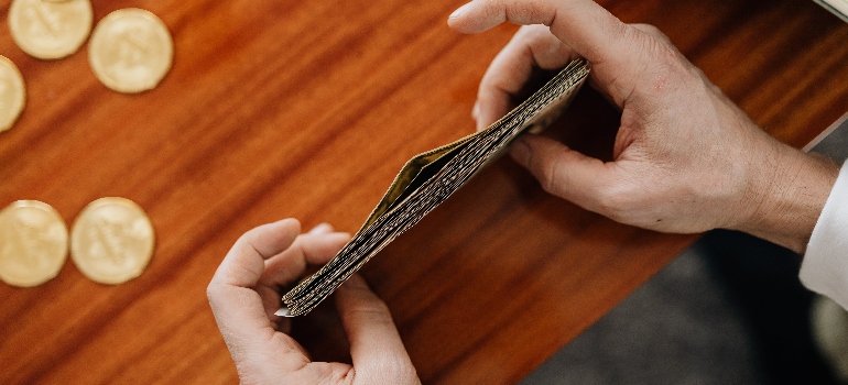 a person holding a pile of money