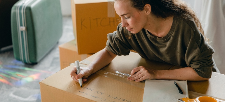 A woman packing boxes.