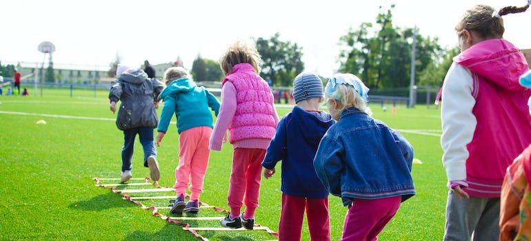 Children playing in a safe and well-maintained playground in one of the family-friendly places to live in Ontario.