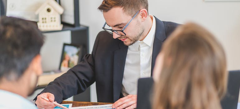 a real estate agent explaining to a couple steps to finding the perfect home in Florida