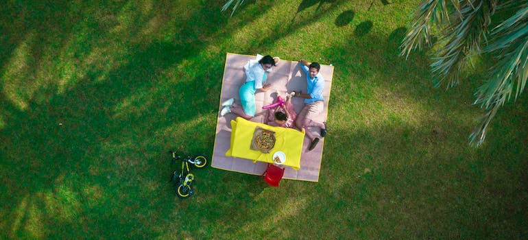 A happy family enjoying a picnic in a park, in one of the best family-friendly places to live in Ontario.