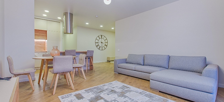 A room with a couch, table, and chairs