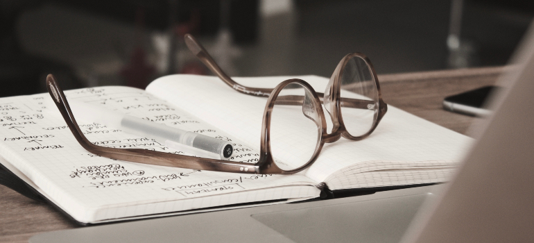 Notebook and glasses on a table