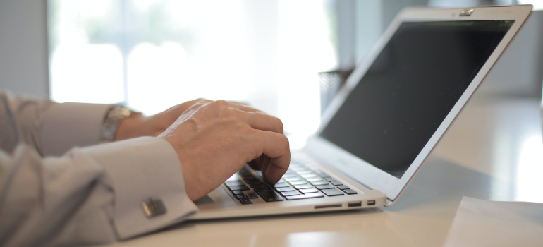 Person using a laptop to look for a new home before moving to Guelph