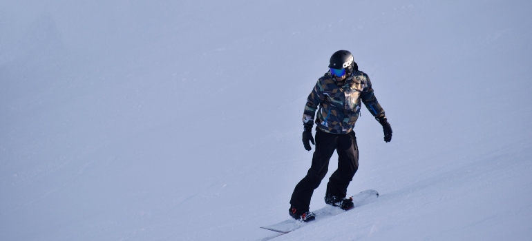 Man snowboarding at one of the best mountain towns to enjoy outdoor activities in Canada