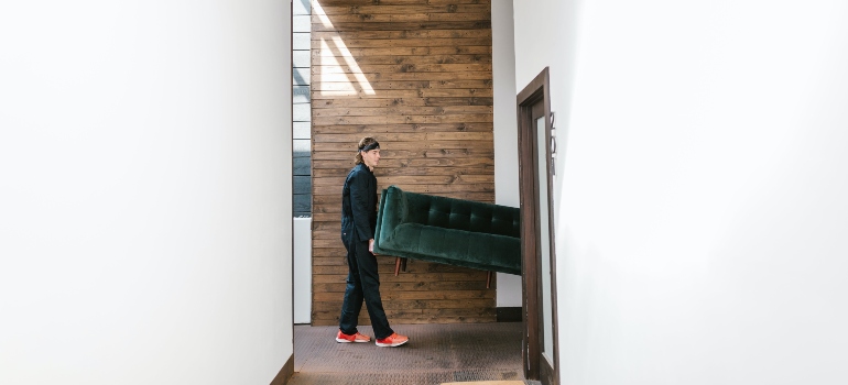 Mover transporting a sofa
