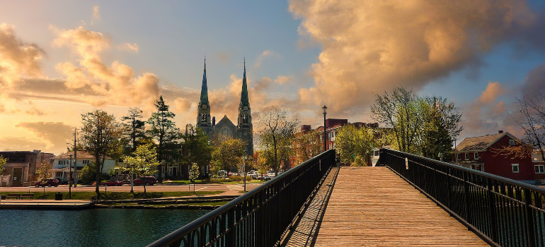 A bridge under a swift sundown, leading to a church in Ottawa.