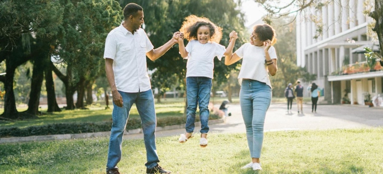 happy family with jumping daughter