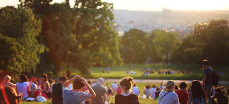 a group of people sitting on the grass