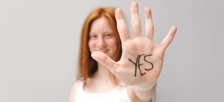 red haired woman showing her palm after moving from Bradford to Orangeville with family
