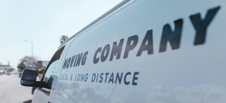 White van with "MOVING COMPANY" written on it
