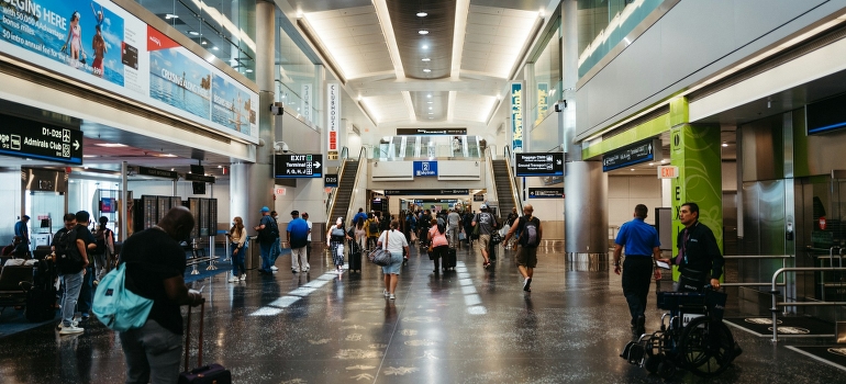 A group of people walking through an airport terminal in Miami.