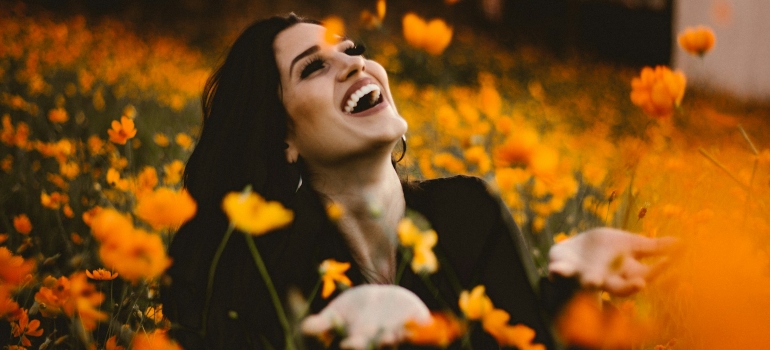 a picture of a girl surrounded by flowers