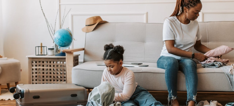 Picture of an adult and a child packing clothes