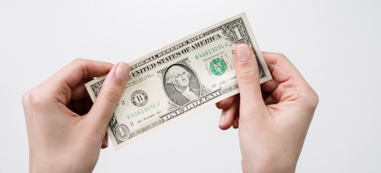 a person holding a dollar bill