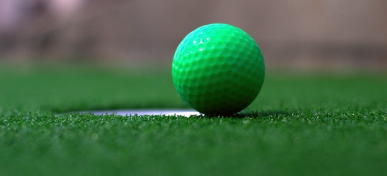 a green golf ball on a golf course