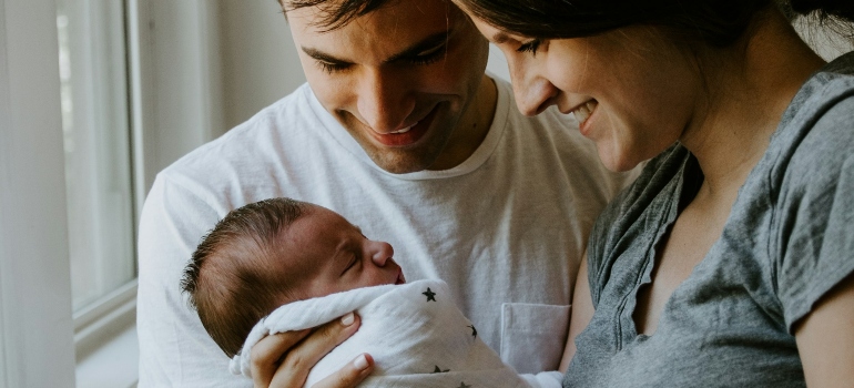 Picture of parents excited about moving to one of the best Canadian places to move to with a newborn