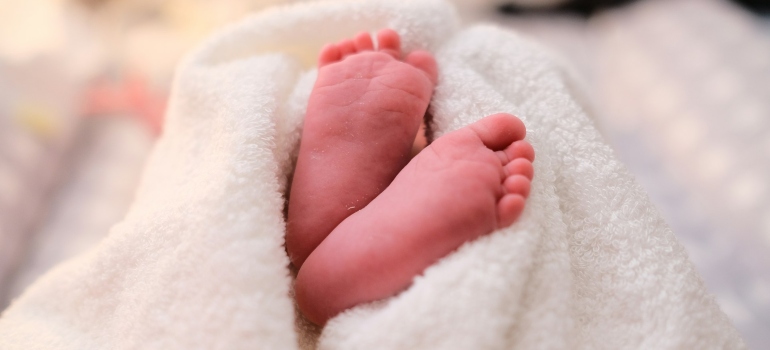 a baby's feet covered in a blanket