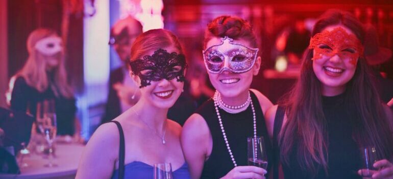 three girls with masks on festival