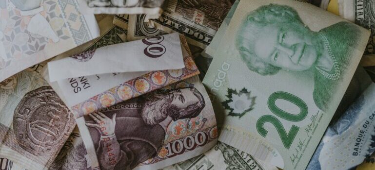 A stack of money with various international currencies