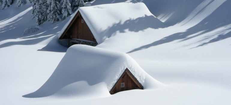 An image of a snow-covered wooden houses.
