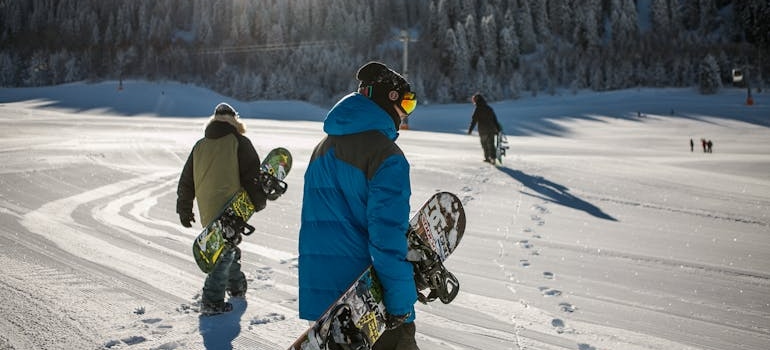 A group of people about to go snowboarding.