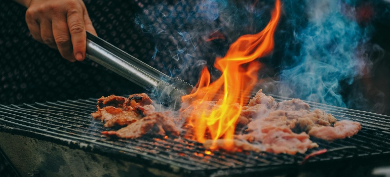 Close-Up Photo of Man Cooking Meat