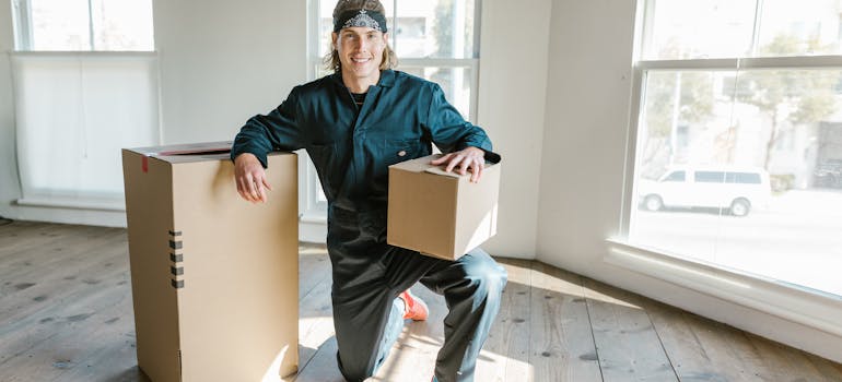 a happy mover belonging to an ideal relocation crew looking at the camera
