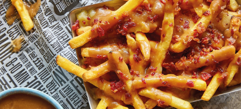 A delicious plate of crispy fries topped with cheese curds and gravy, a popular Canadian dish known as poutine.