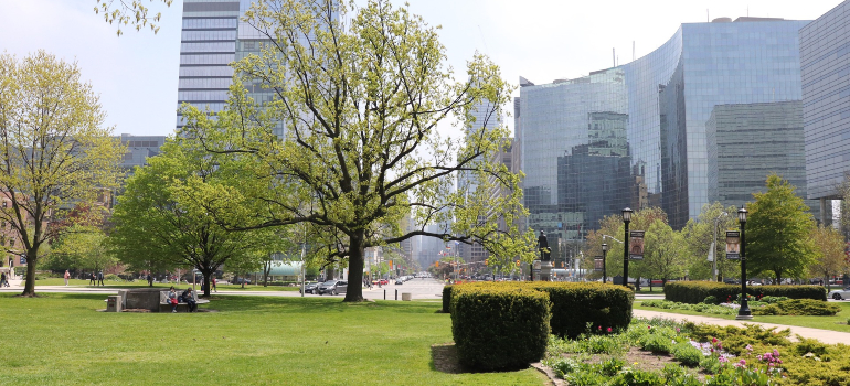 A quiet park with city buildings, perfect for those moving to Scarborough seeking balance.