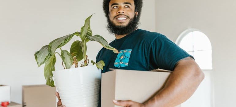 A mover holding a box and a vase