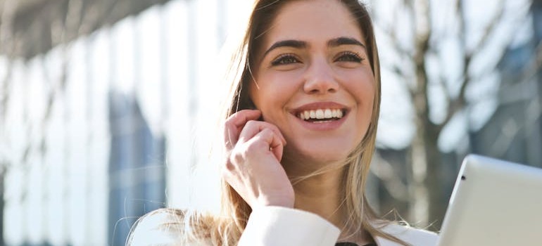 A woman on a phone call, ready to research & compare different moving companies in Canada