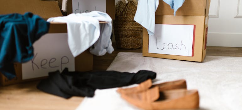 clothes and shoes thrown over boxes