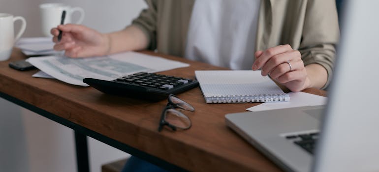 a woman holding a pen and calculating