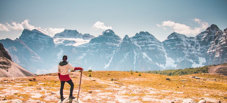 a man standing with a hiking road in one of the places in Canada for singles
