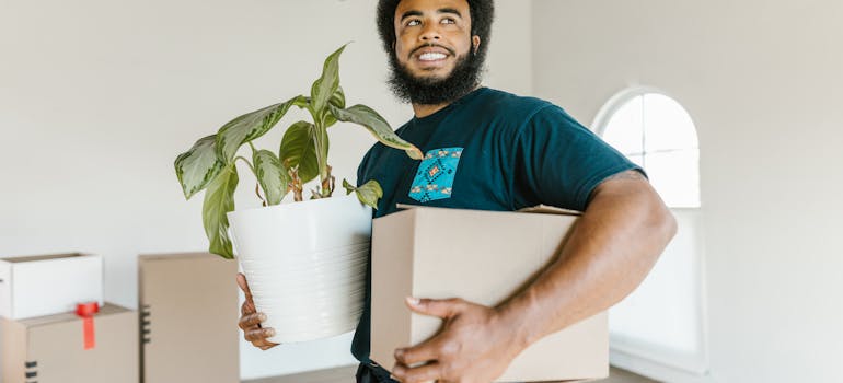a man using packing materials that reduce your environmental footprint during your move from Toronto