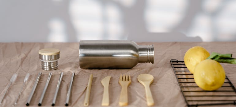 wooden and steel cutlery on the table with some lemon aside